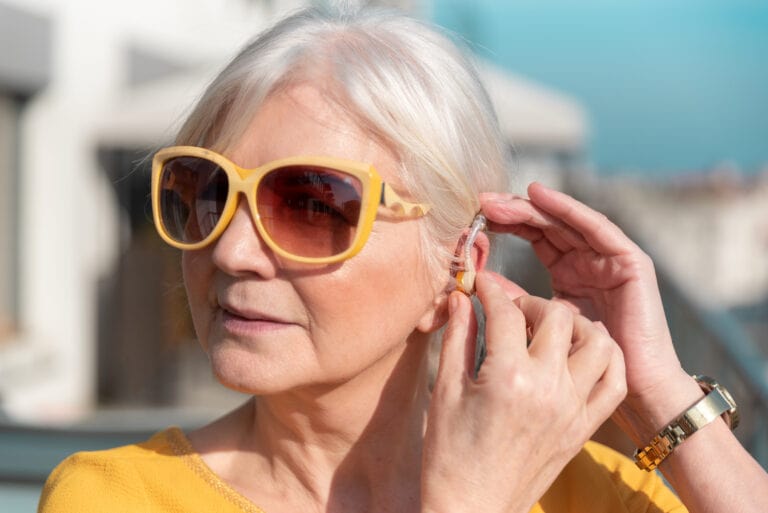 women with sunglasses and hearing aids