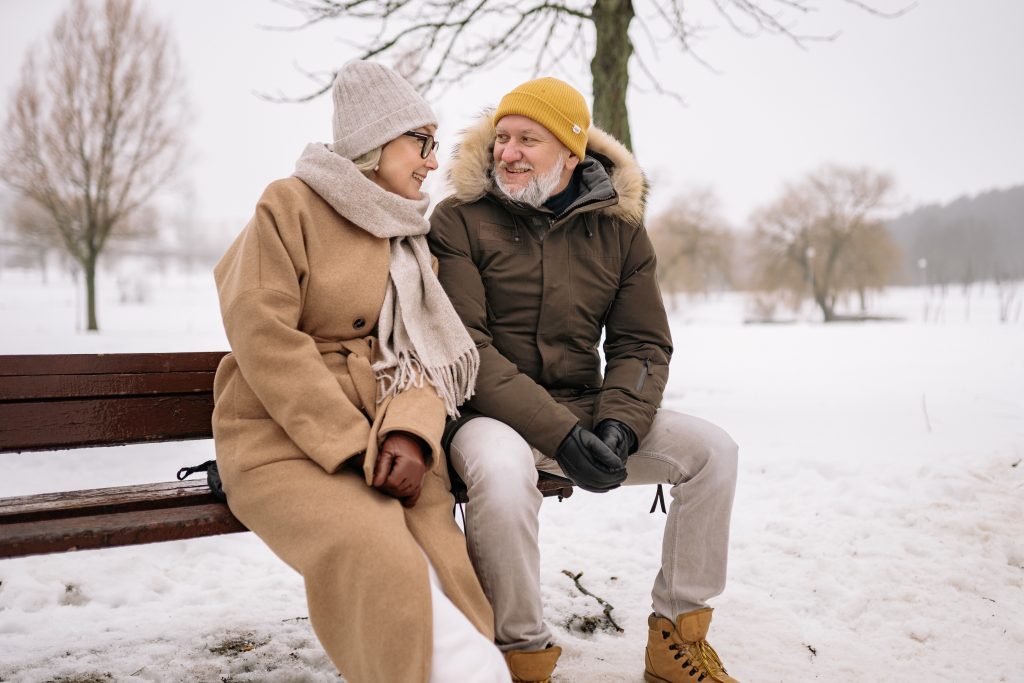 couple sitting on bench in winter